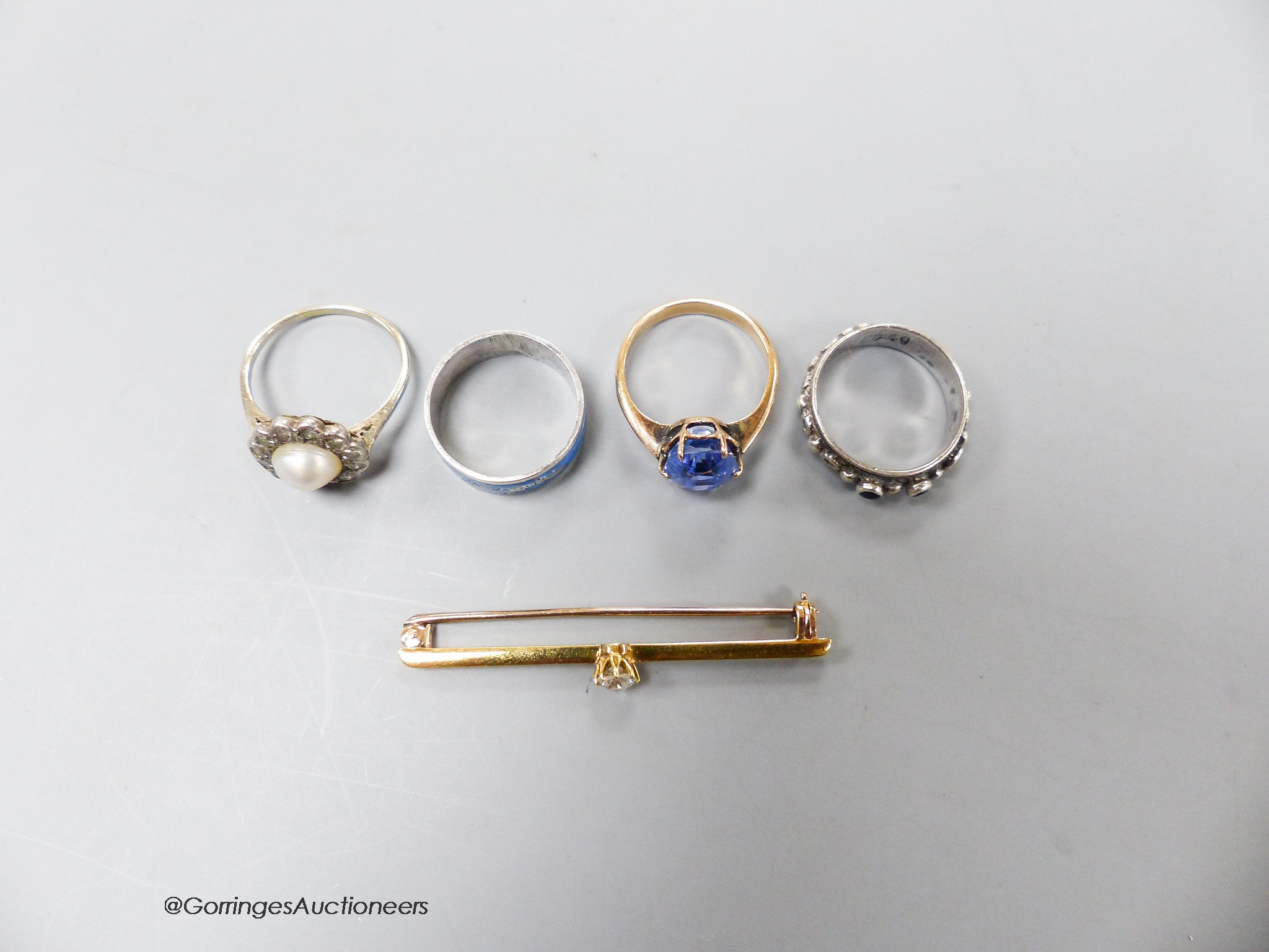 A yellow metal, split pearl and diamond set cluster ring, size K/L, an oval sapphire ring, size H, a yellow metal and diamond set bar brooch and two white metal rings.